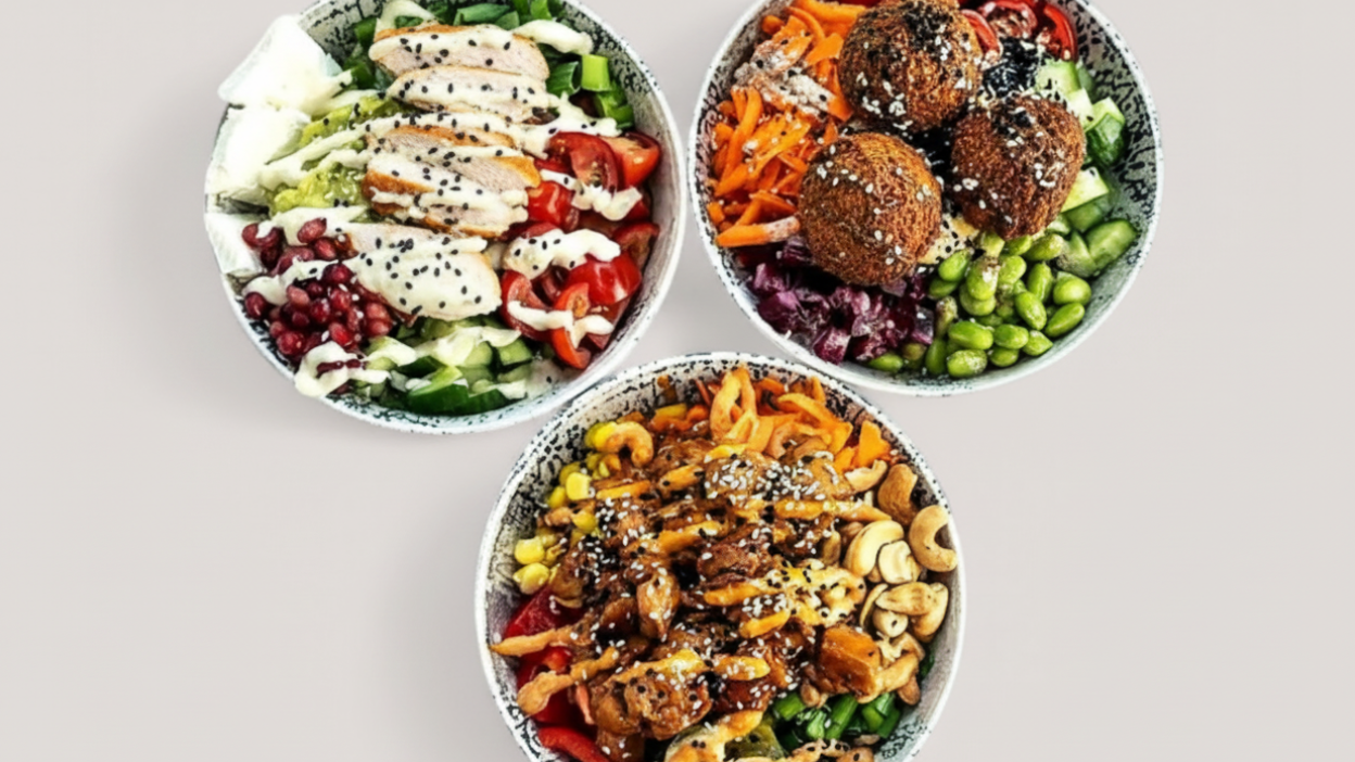 Drei bunte Bowls mit Falafel Cashewkernen und Gemüse für Mittagstisch im Cafe Köln Zollstock